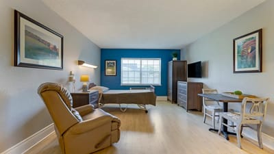 A cozy resident room with a view and furnishings