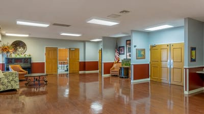 Bright and spacious common area with chairs and decor