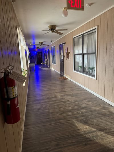 A well-lit interior hallway with wooden walls