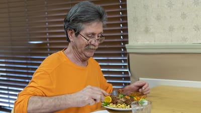 Resident enjoying a meal in the dining room