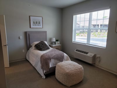 Cozy single bedroom with a bed and window view