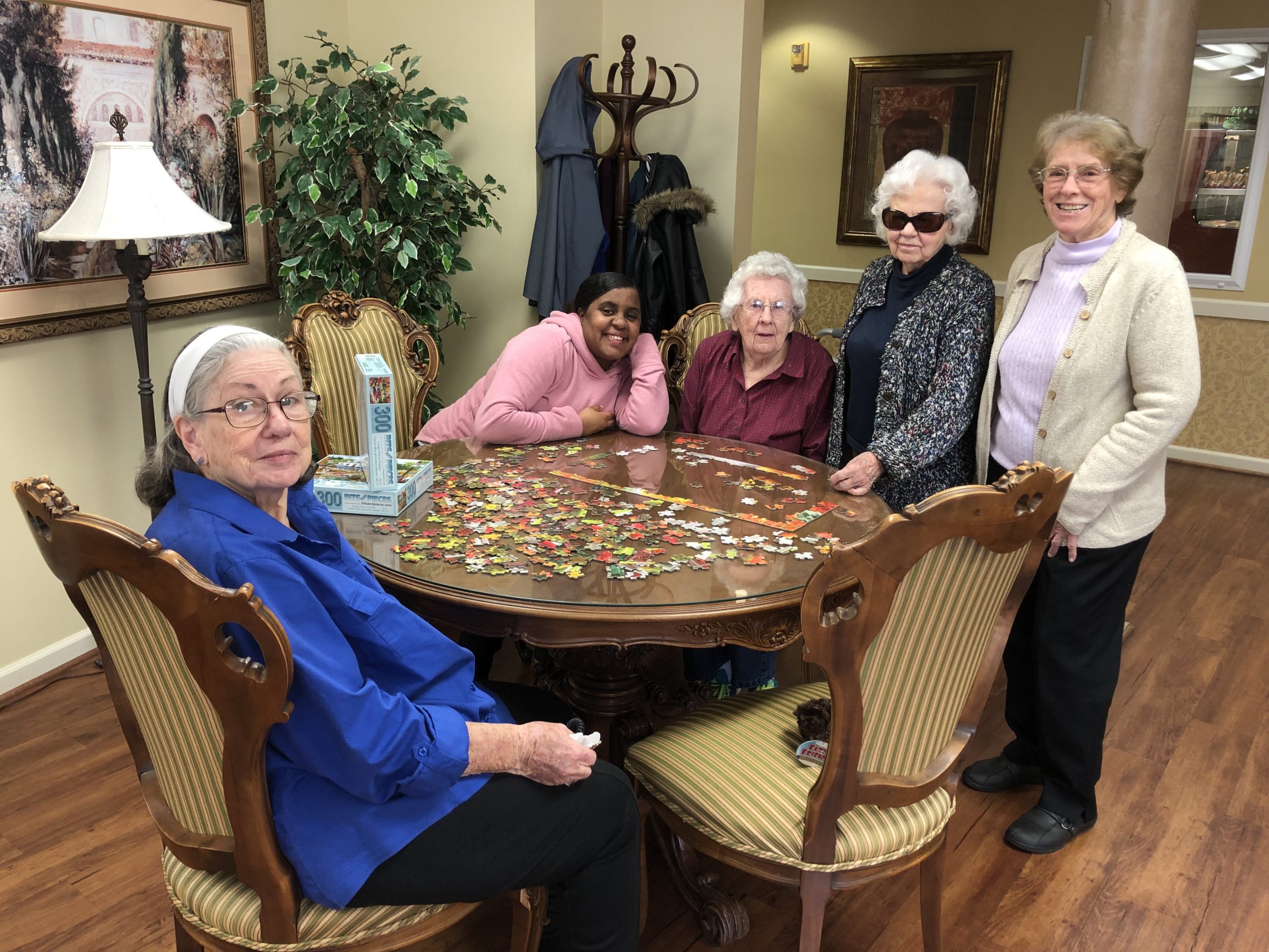 Residents working on a puzzle in a common area