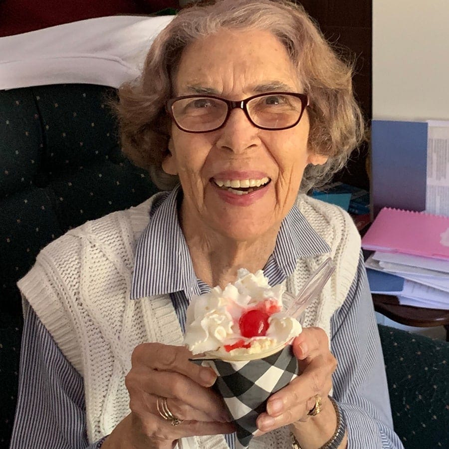 Resident enjoying a dessert in a cozy environment