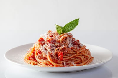 Plate of spaghetti with basil and cheese