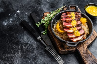 Plated gourmet meal with grilled meat and sauce