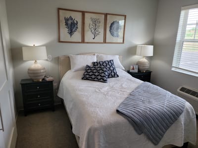 Cozy private resident room with bed and decor