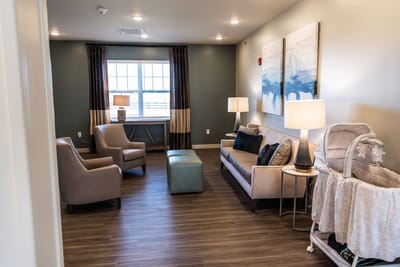 Cozy lounge area with seating and decor in a senior living facility