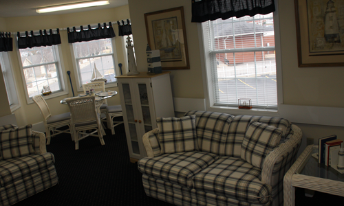 Cozy common area with seating and windows.