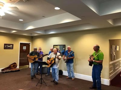 Residents enjoying a musical performance in a common area