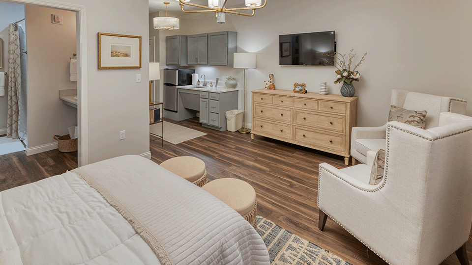 A cozy room with a bed and sitting area