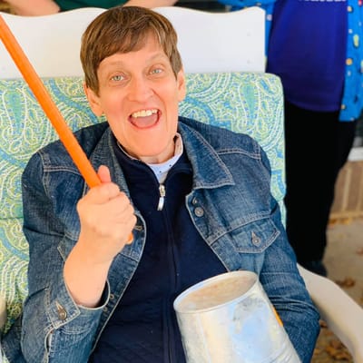 Resident enjoying a lively activity with music