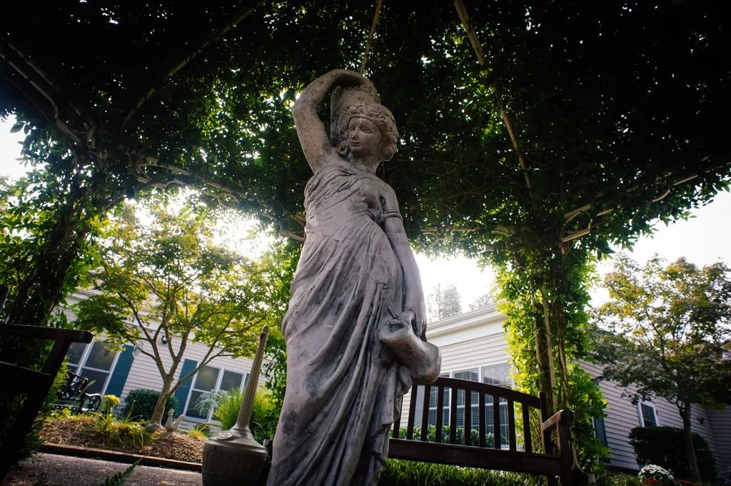 Statue under a gazebo in a garden area