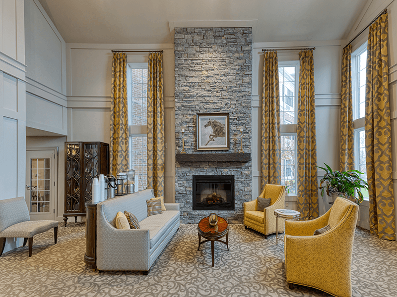 Bright and welcoming common area with seating and fireplace