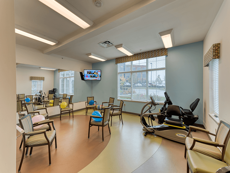 Fitness room with equipment and exercise chairs