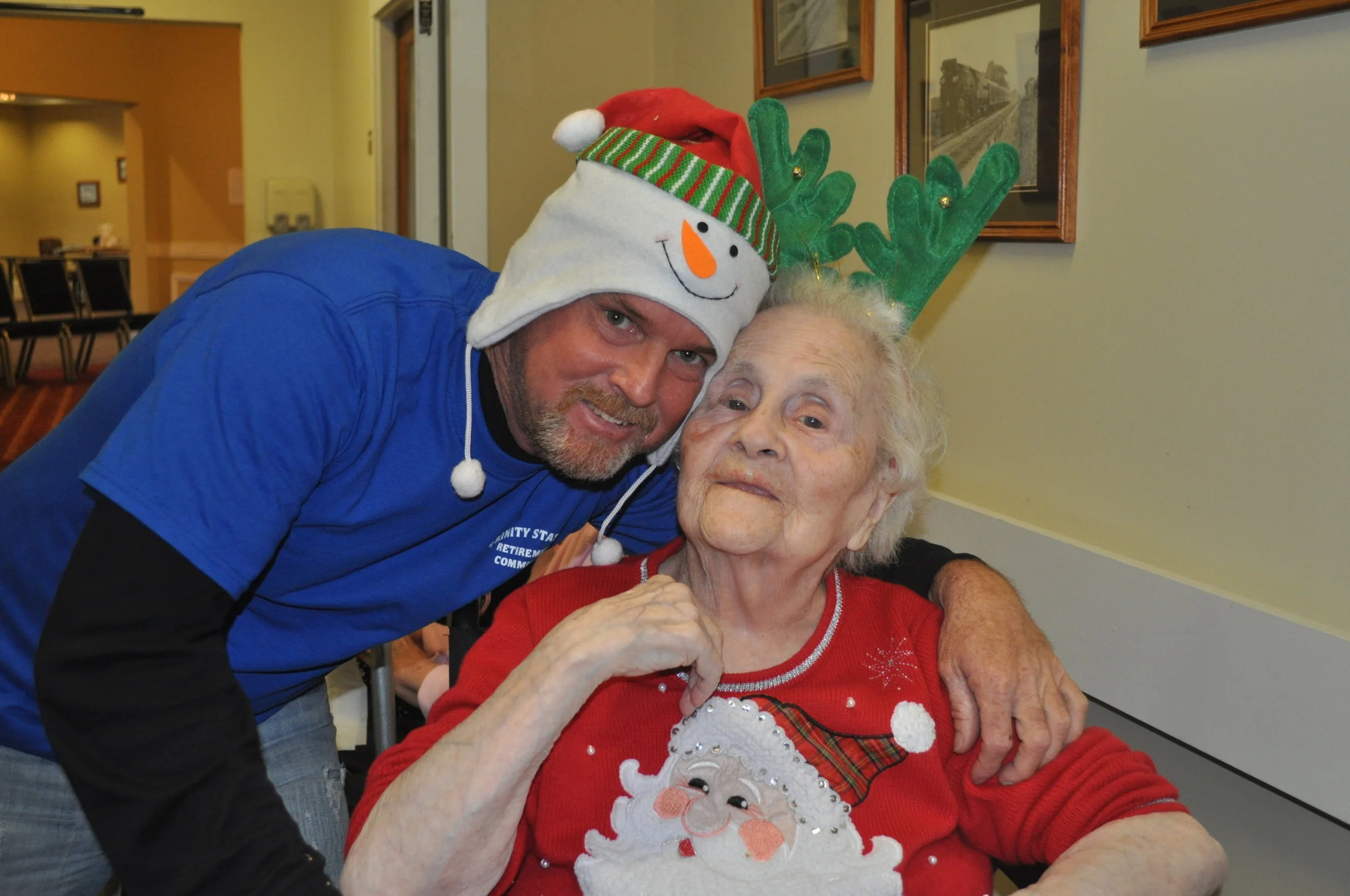 Resident and staff celebrating with festive attire