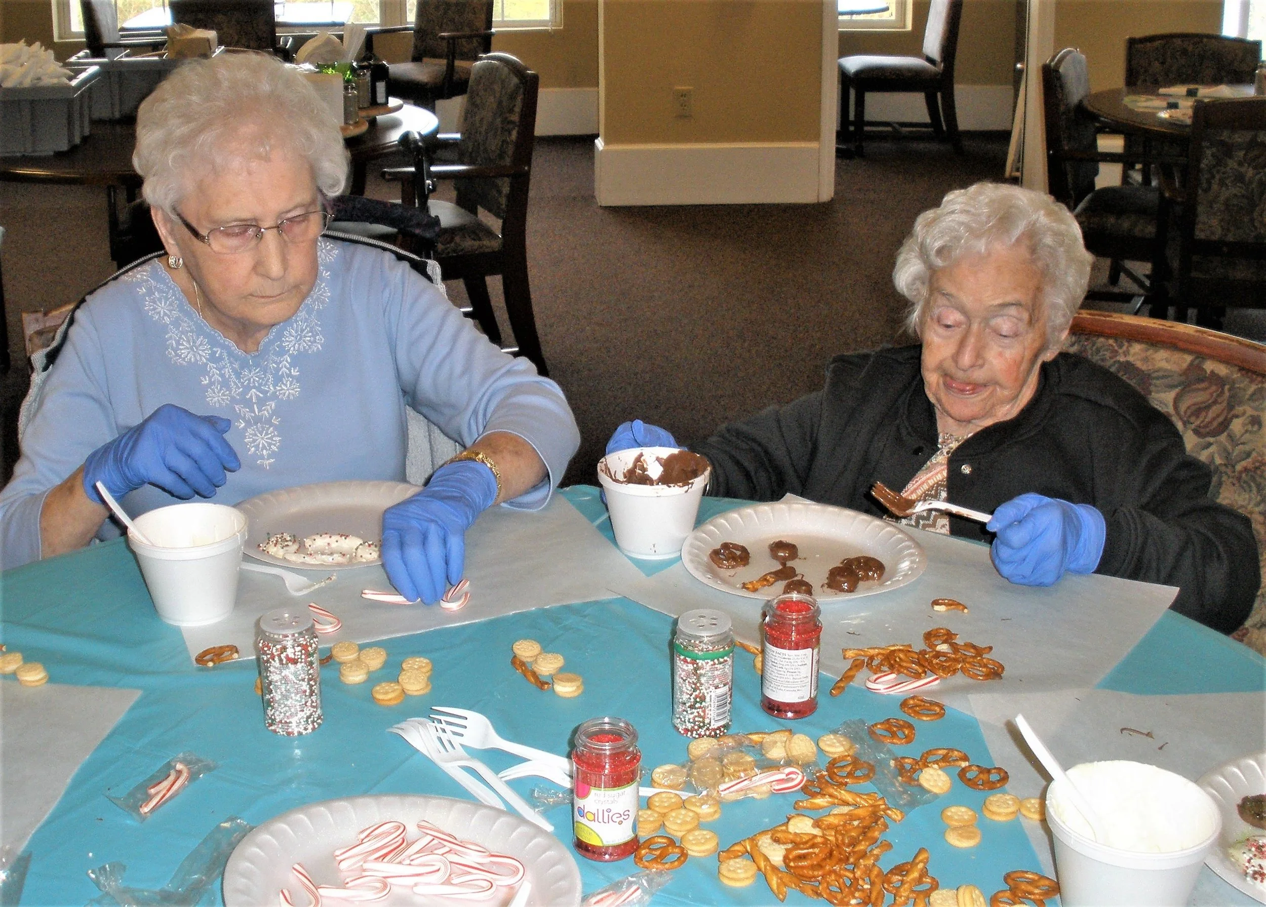Residents making holiday treats in an activity room