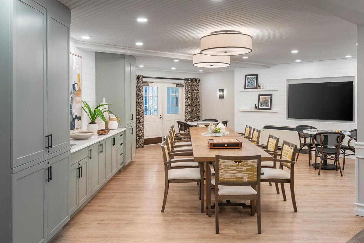 Bright common area with a large table and chairs