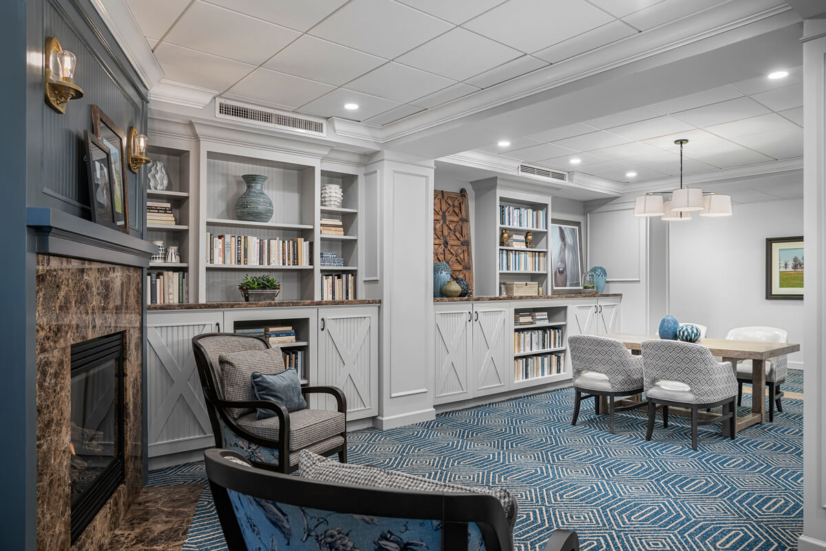 A cozy common area with bookshelves and seating