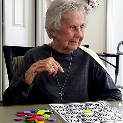 Resident playing bingo in a common area