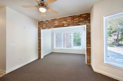 Bright interior space with a window and brick accent