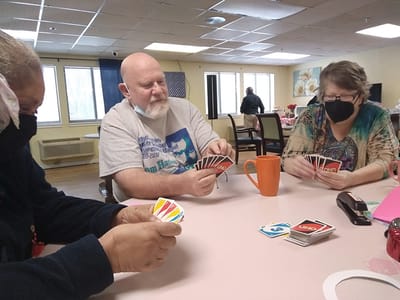 Residents playing UNO in a common area