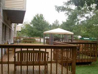 Outdoor deck area with seating and a gazebo