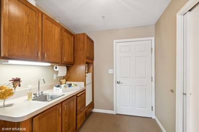 Bright kitchen area with wooden cabinets