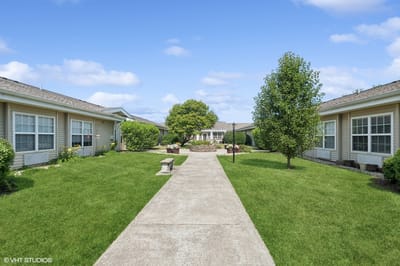 Pathway through landscaped outdoor space with buildings