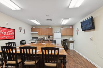Bright dining area with a large table and kitchen items