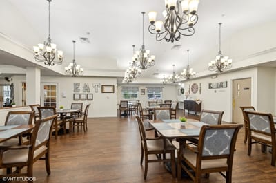 Interior view of a dining room with tables and chandeliers