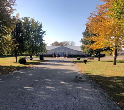 Exterior view of Guest Home Estates Vii surrounded by trees