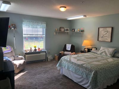 Cozy resident room with a bed and seating area