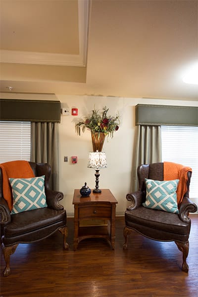Cozy common area with comfortable chairs and decorative lamp