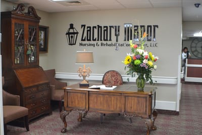 Interior lobby area with floral arrangement and desk