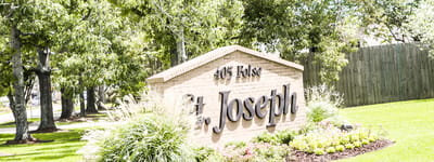 Sign for St. Joseph of Harahan surrounded by greenery