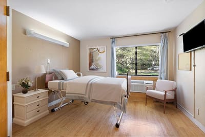 Private resident room with hospital bed and natural light