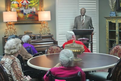 Residents listening to a speaker in a common area