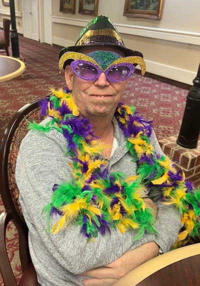 Resident celebrating with colorful accessories