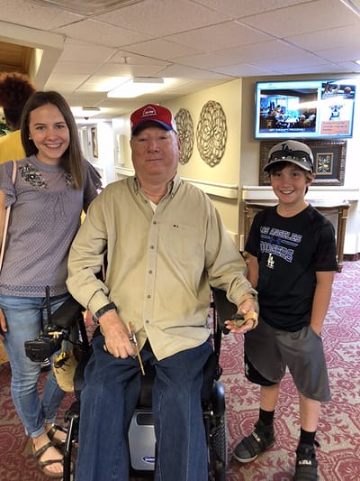Residents posing with visitors in a common area