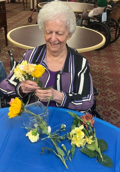 Resident arranging flowers in a common area