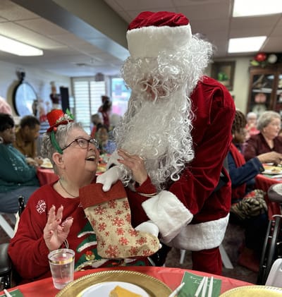 Resident enjoying a festive activity with Santa