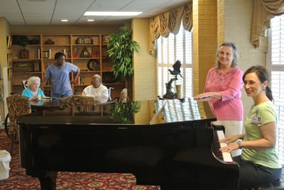 Residents and staff enjoying music in a common area