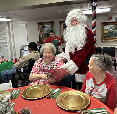 Residents enjoying a holiday celebration with Santa Claus