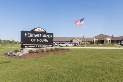 Exterior view of Heritage Manor of Houma with signage