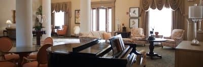 Bright interior common area with seating and piano
