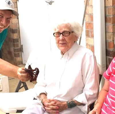 Residents enjoying an outdoor activity with a staff member