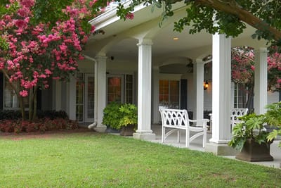 Inviting outdoor porch area with flowering trees