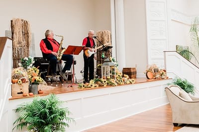 Musicians performing in a decorated indoor activity space