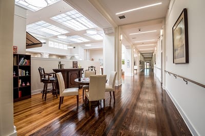Bright and inviting common area with seating and wood floors