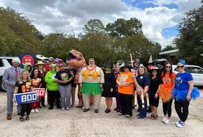 Staff and residents in costumes during a Halloween celebration